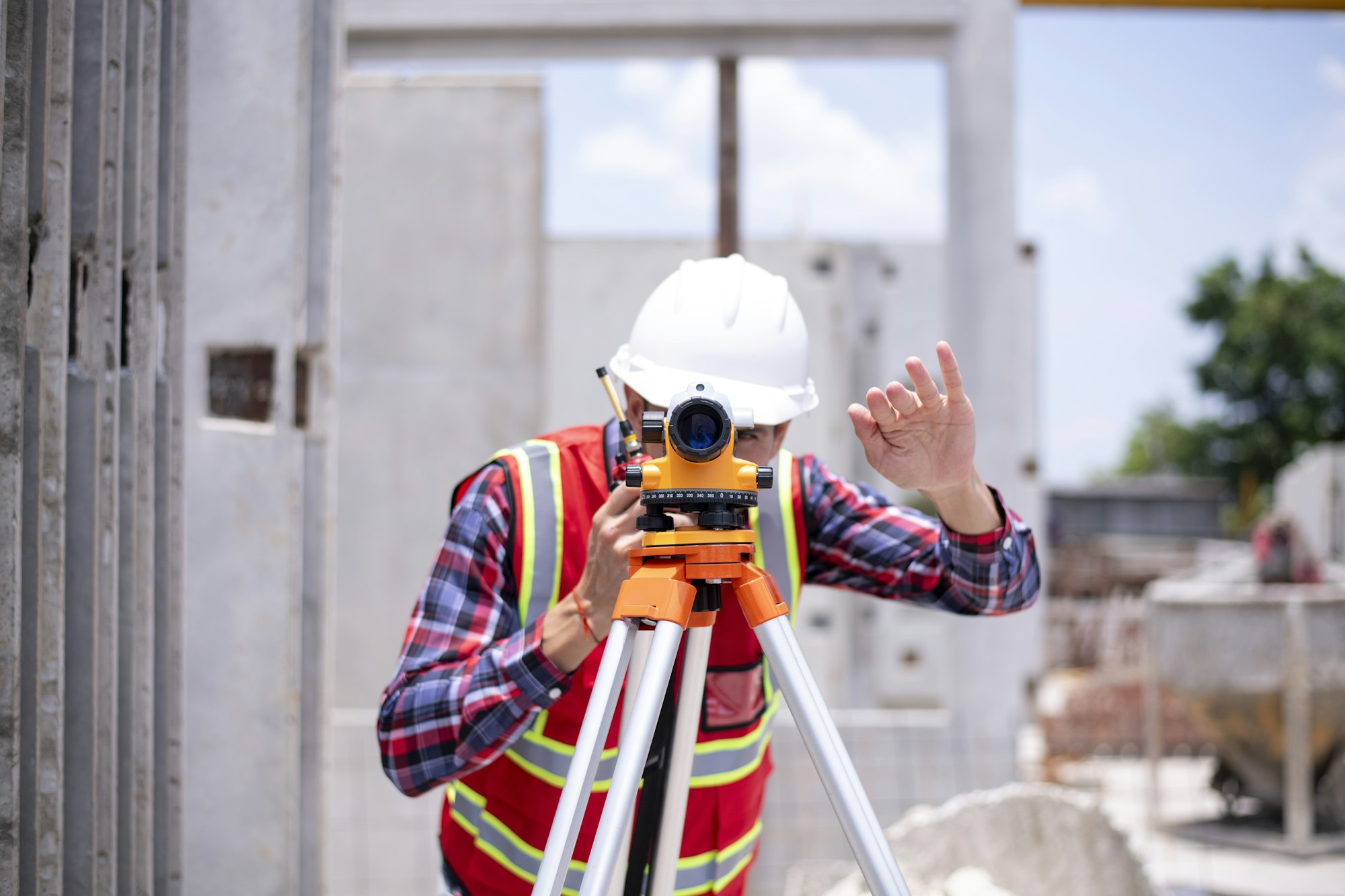 Engineer or worker construction architecture wear safety uniform and helmet with equipment theodolit