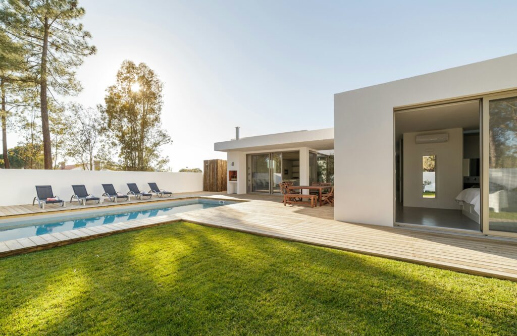 Modern house with garden swimming pool and wooden deck